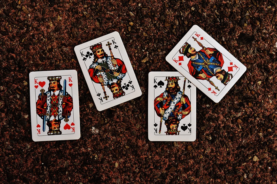 Four King Cards on a Cork Board used for Playing Kings Corner Card Game