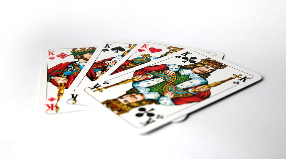 Four King Cards on a White Table used for Playing Kings Corner Card Game