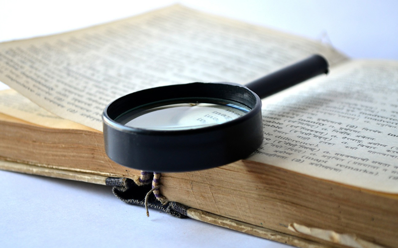 magnifying glass and a dictionary