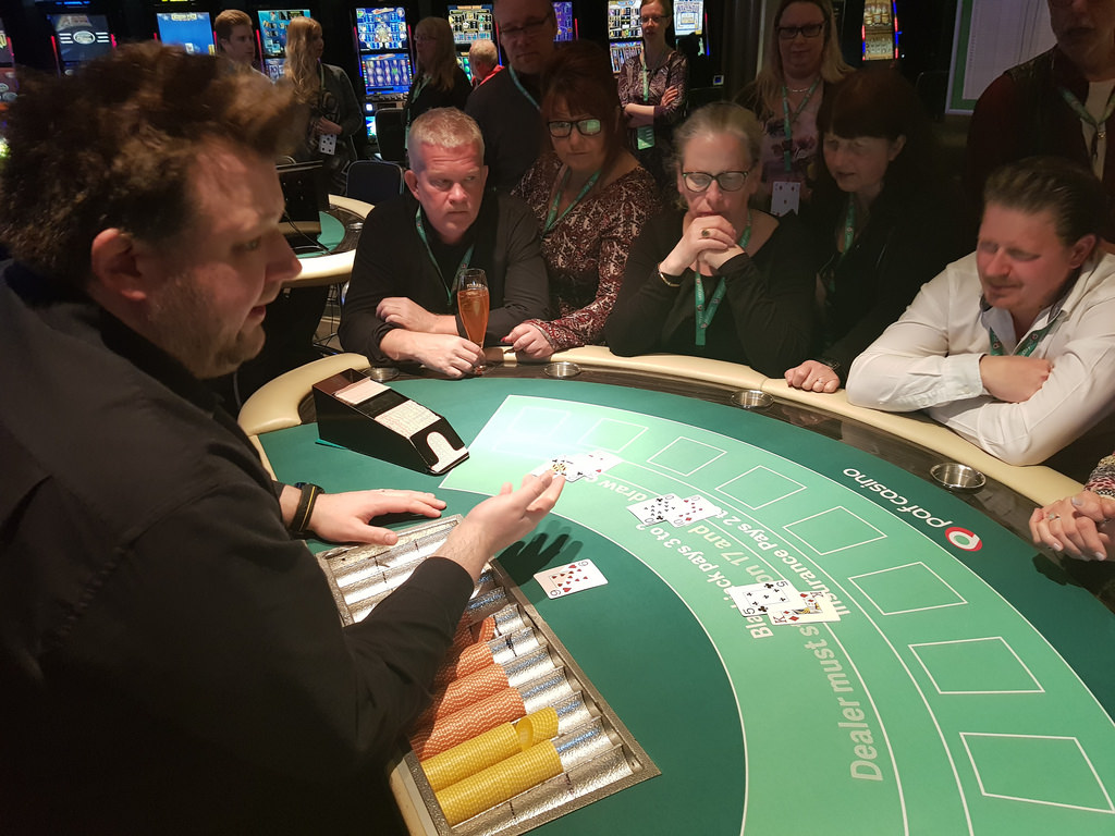 Men and Women Starting to Play the Blackjack Card Game at a Casino